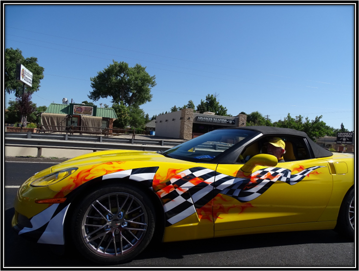 A yellow sports car with a checkered flag on the side

Description automatically generated